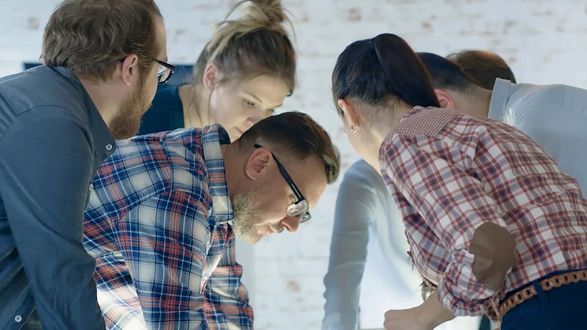 Several individuals sharing ideas and collaborating in a group setting.
