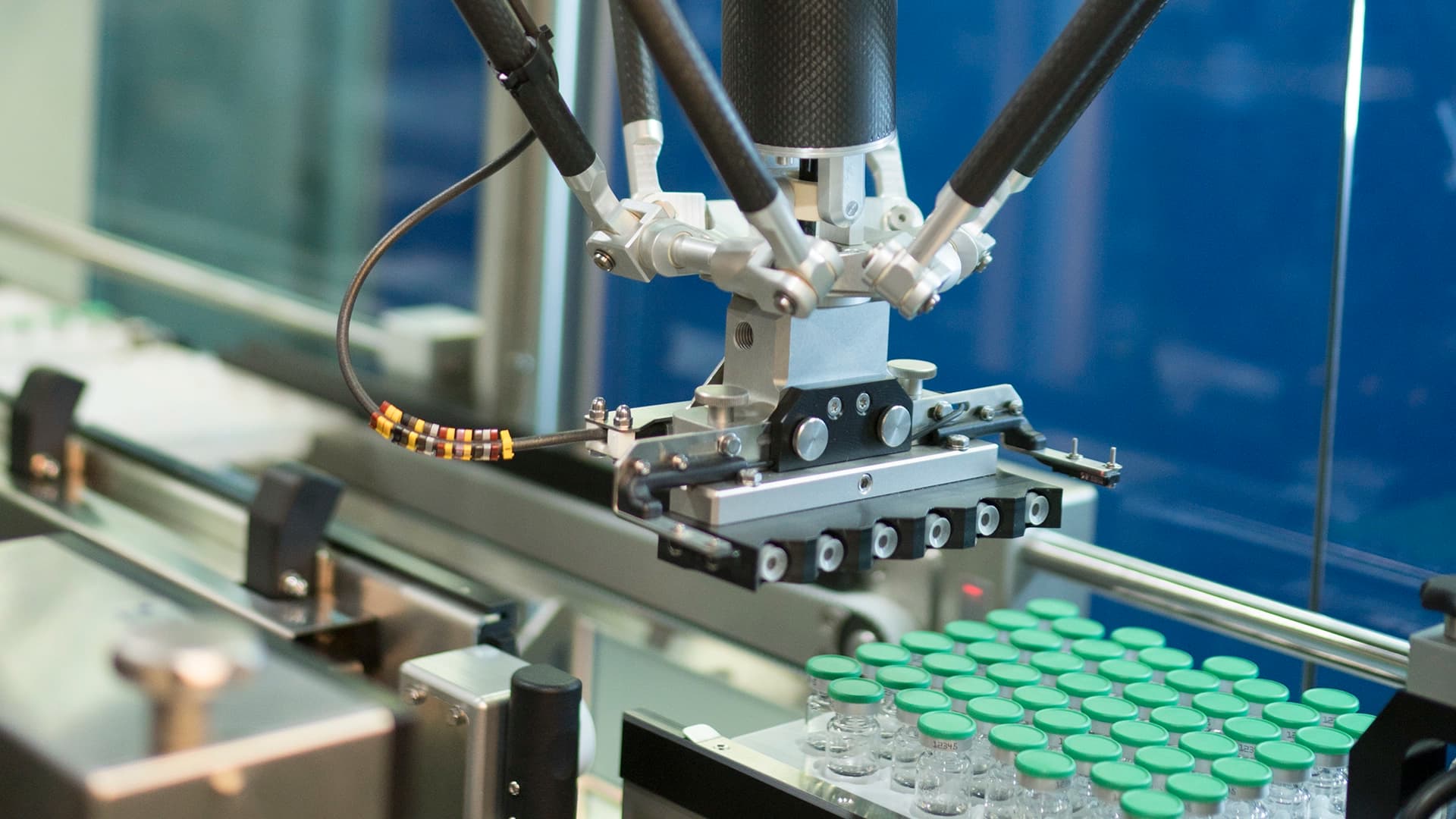 Körber pharma employee holding a tablet wearing protective gear similar to medical staff.