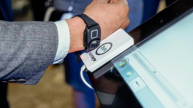 A person holds a smartwatch, showcasing the growing interaction between humans and technology.