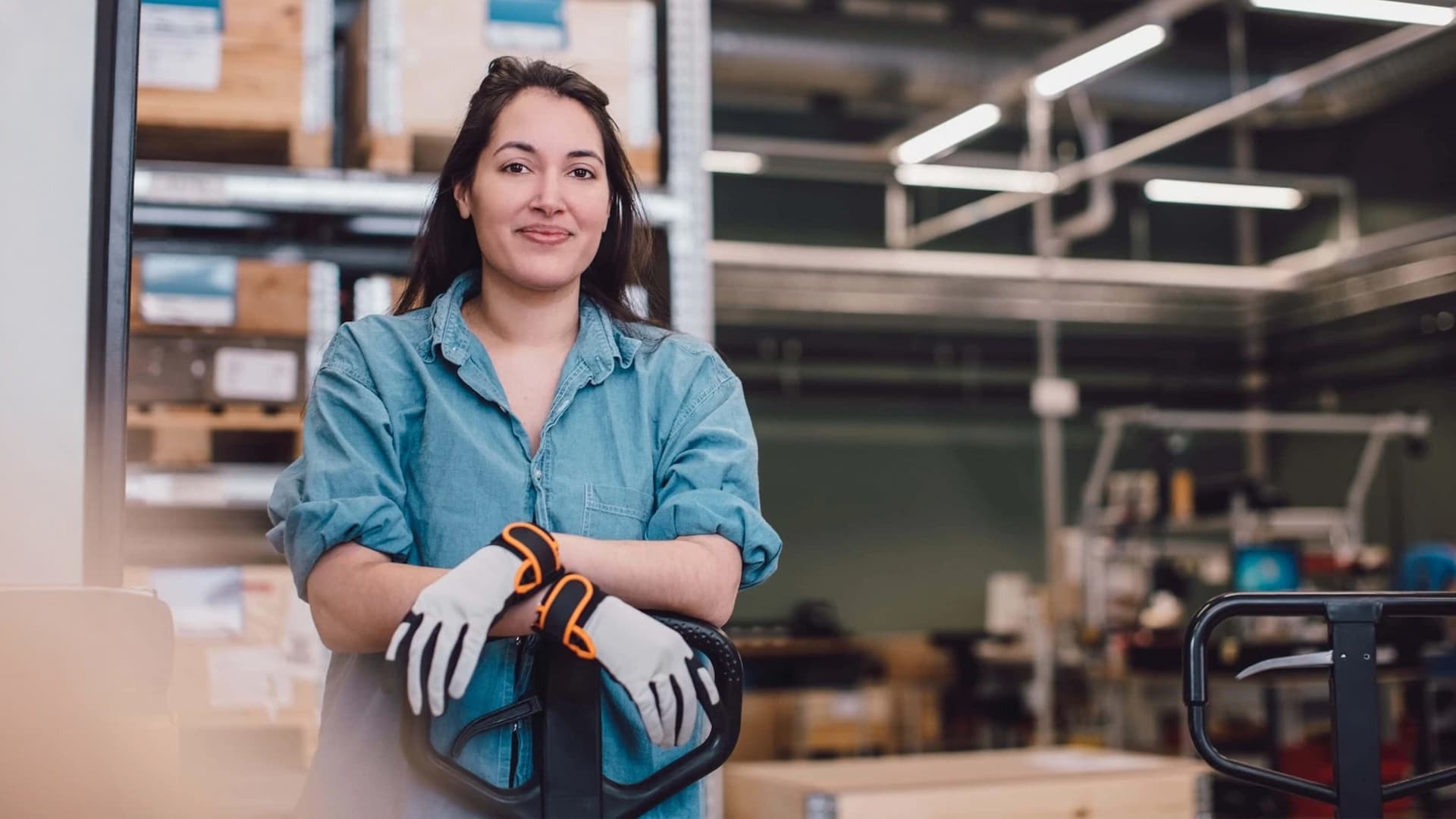 Women wearing workwear standing in a warehouse