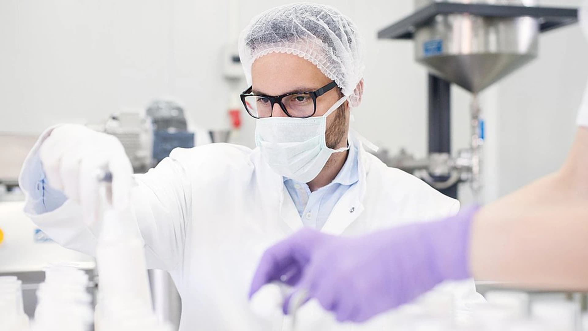 A man and woman work together in a lab, focusing on cell and gene therapies