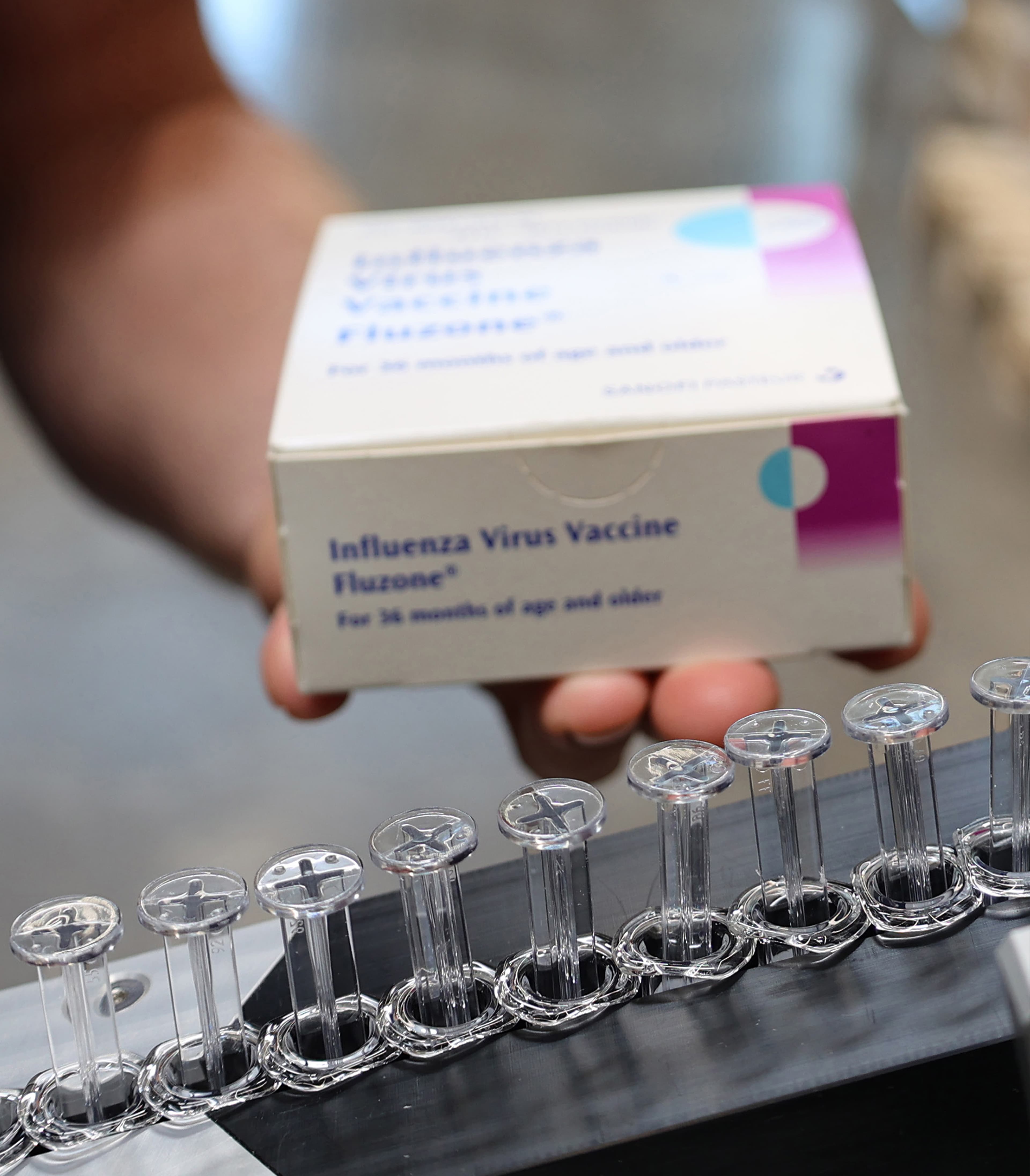 Close up of hand holding Influenza flu packaging