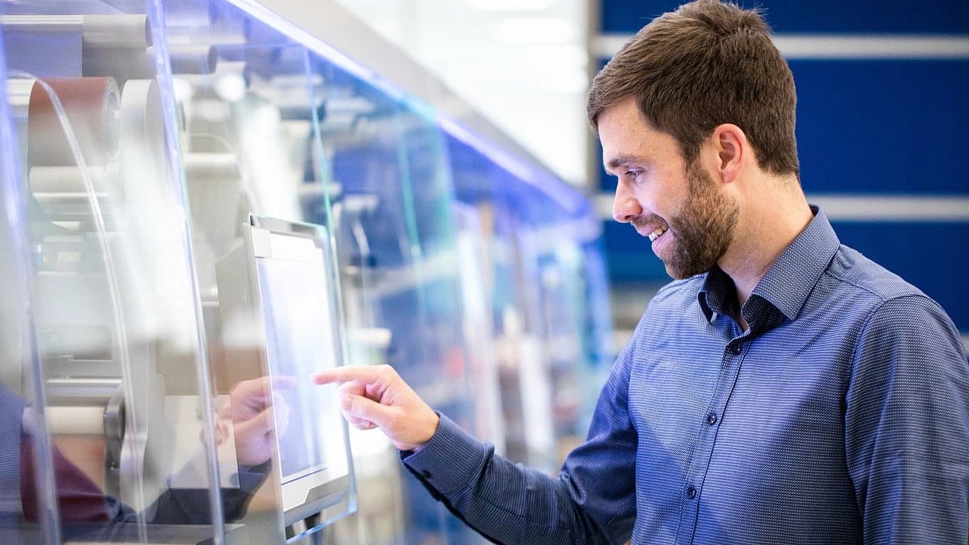 Man working on a laptop in a factory