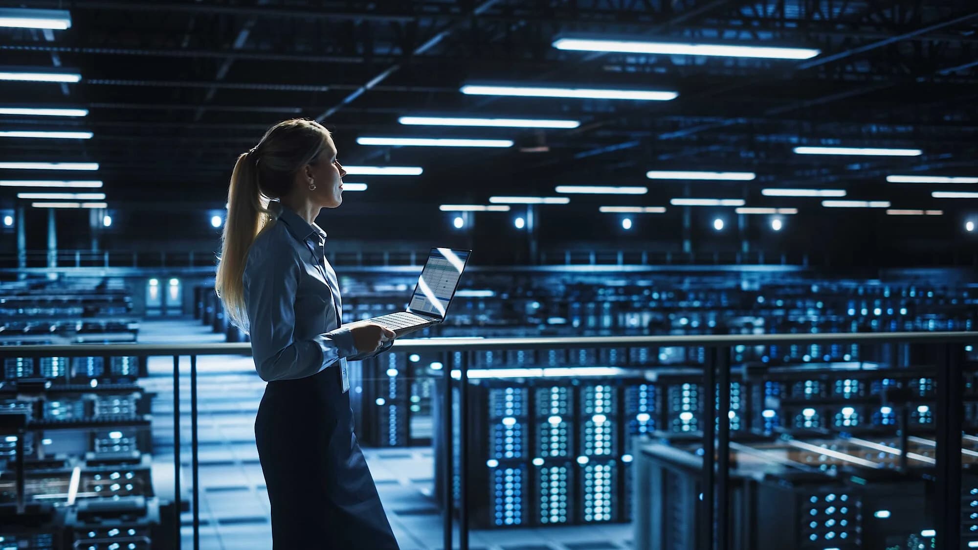 Femail engineer holding a computer, dealing with information security issues.