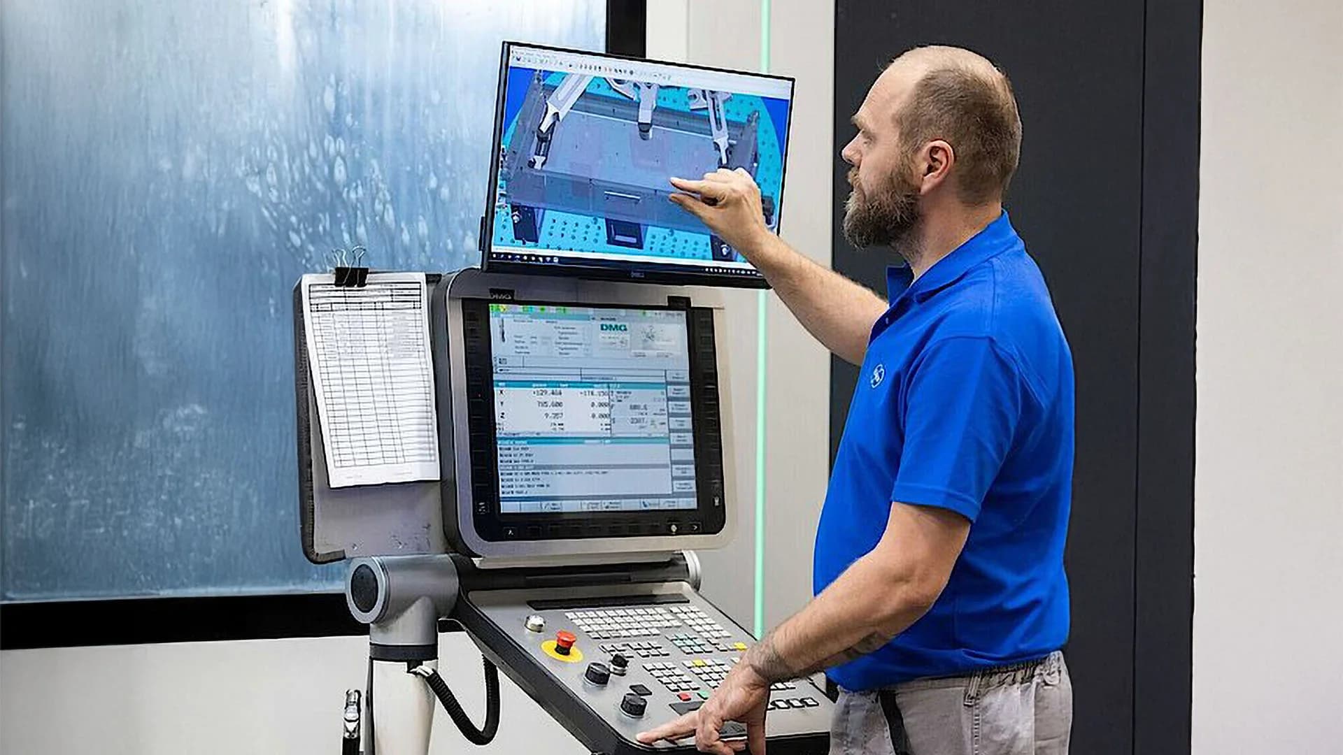 A man works on a computer, focusing on application and product security for a machine