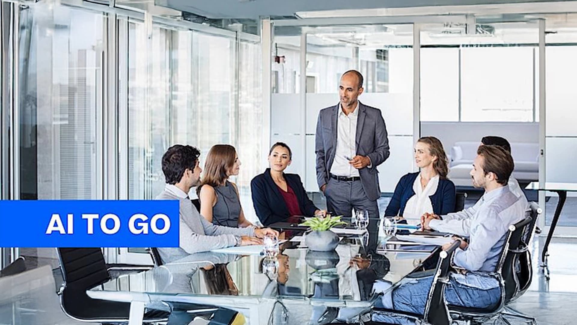 A manager talking to their team in an office room.