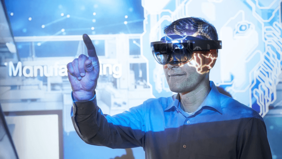 Man with virtual goggles in a manufacturing fair.