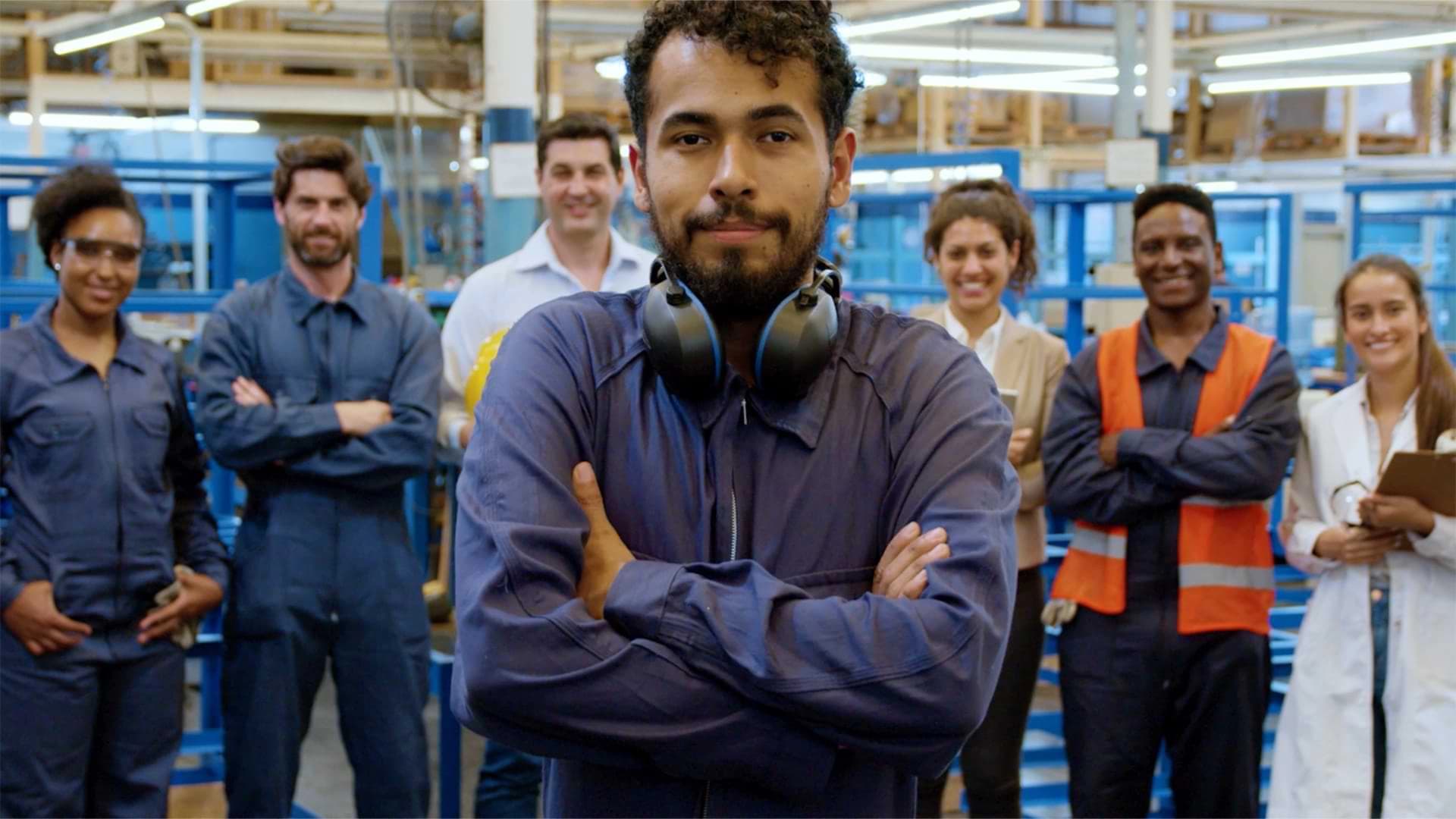 A group of people stands together in a factory