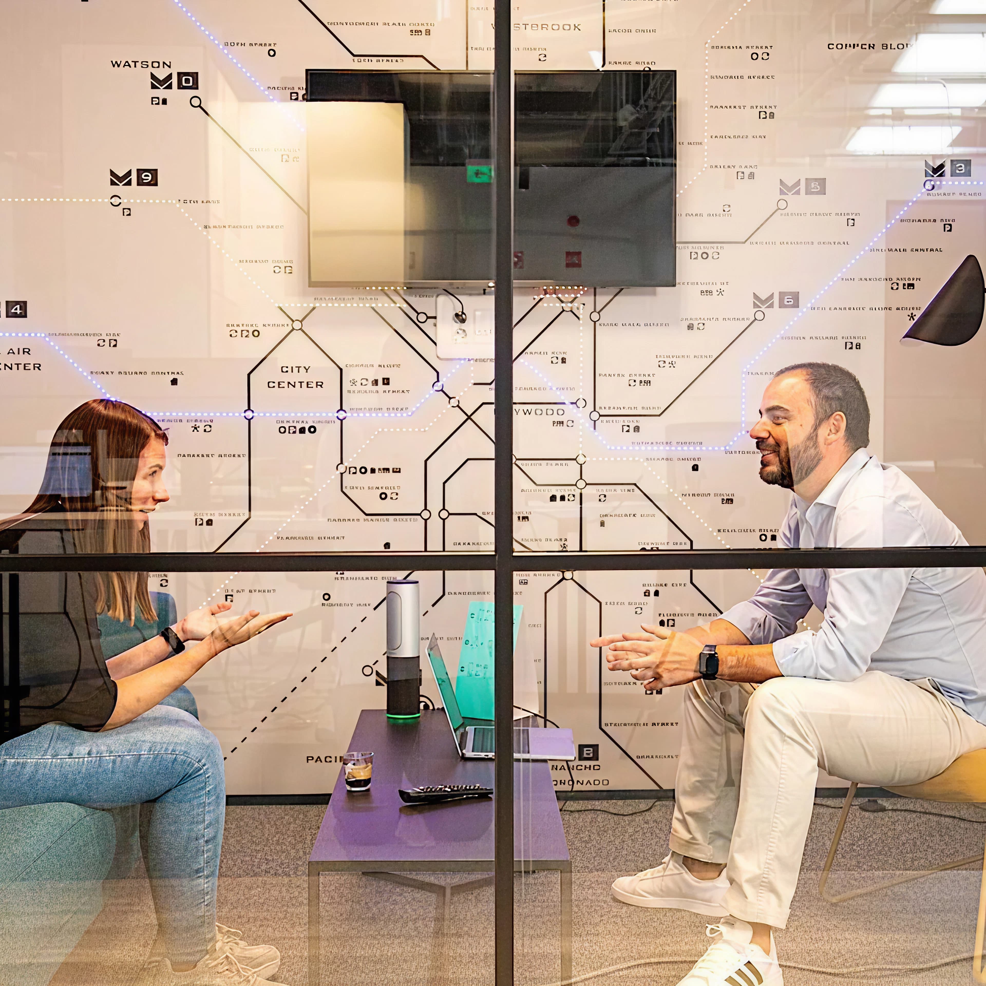 A man and a woman talling in a meeting room