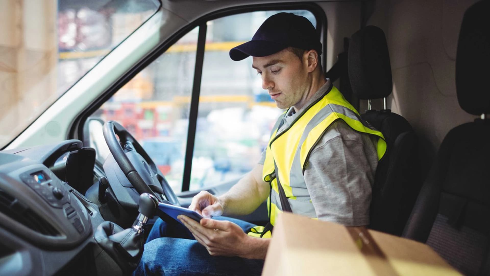 a man inside a vehicle focused on a device