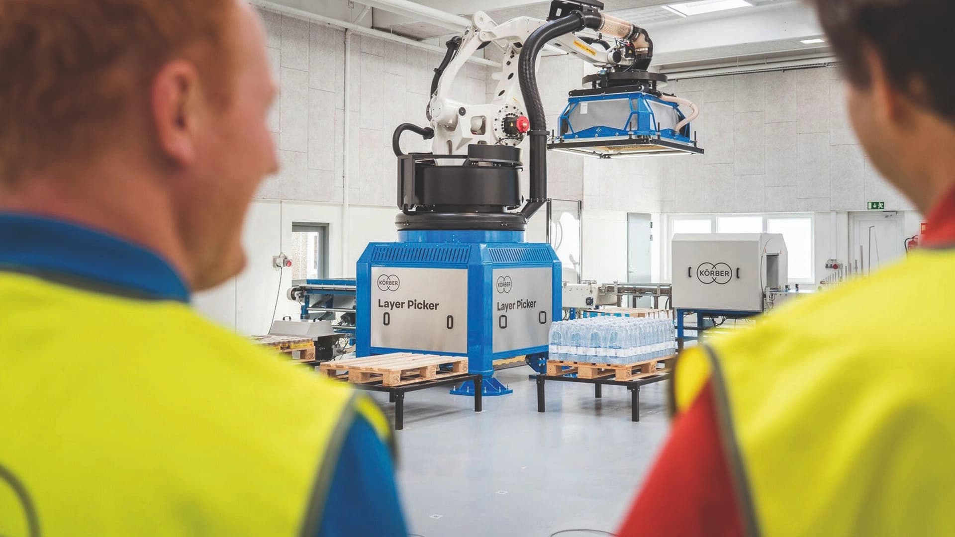 people working on a warehouse with a layer picker on the background