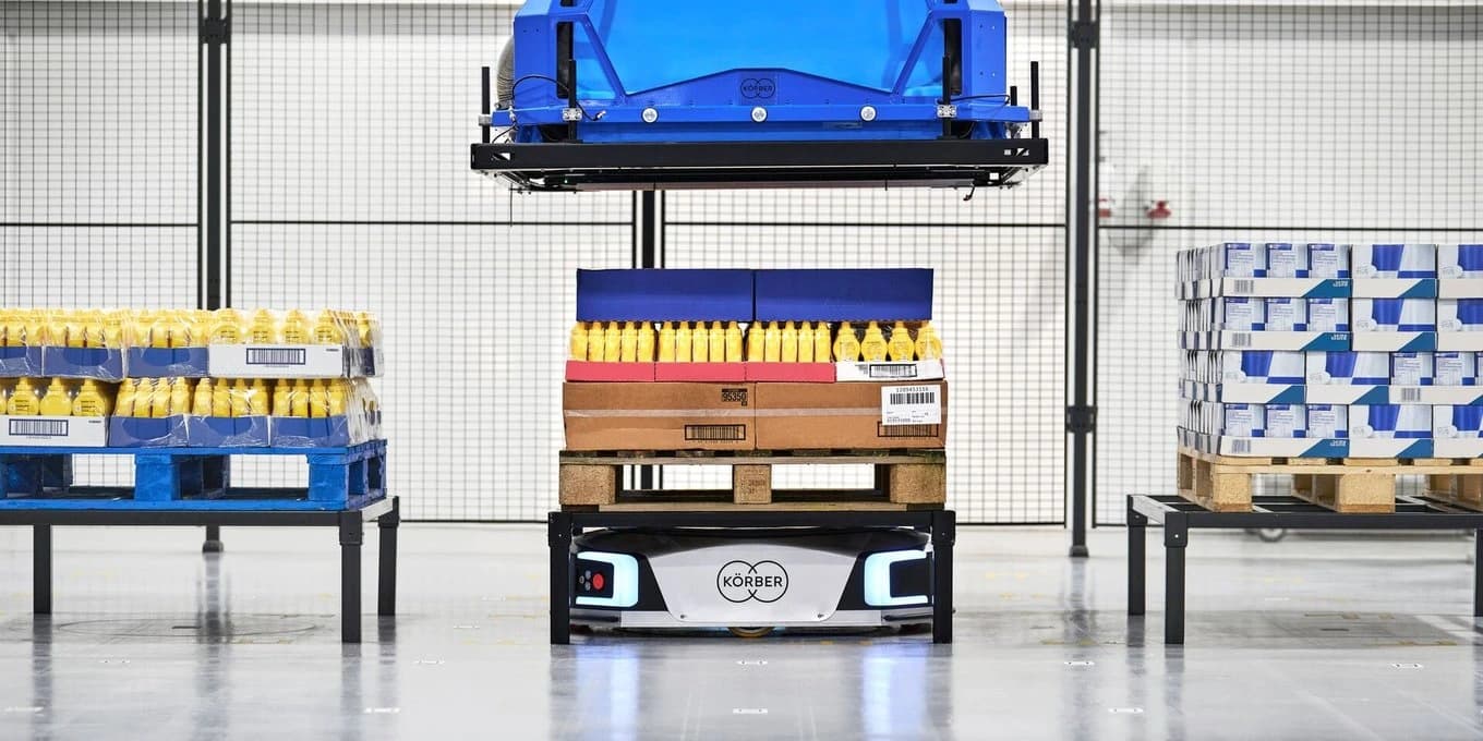 a layer picker and an amr in a warehouse environment