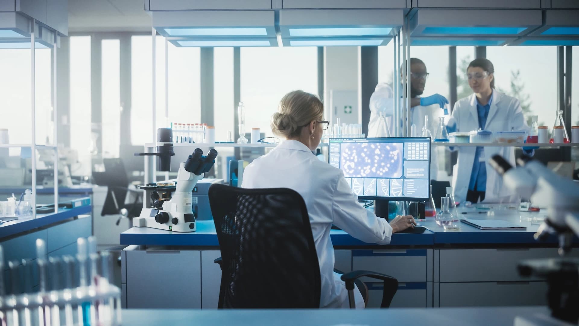 a woman working on software implementation in a lab environment