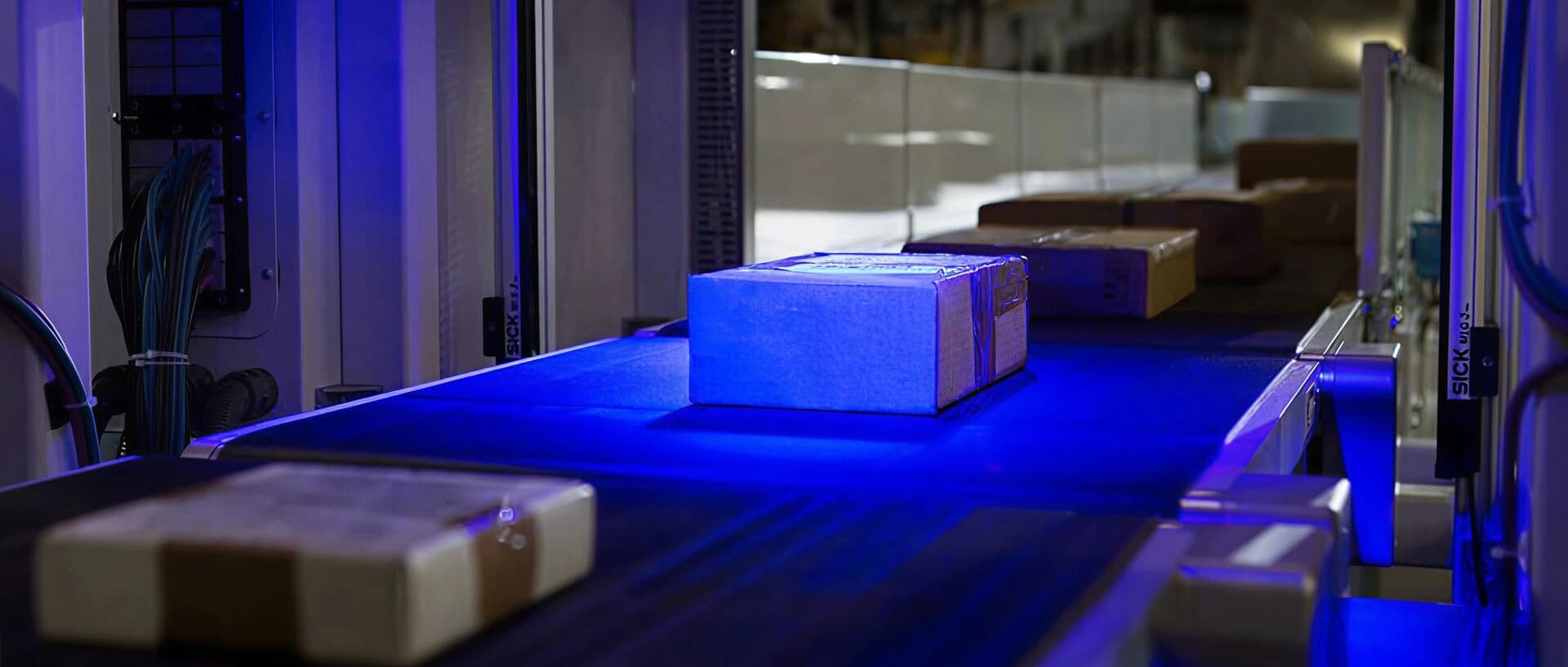 Boxes being inspected in a parcel and mail system.