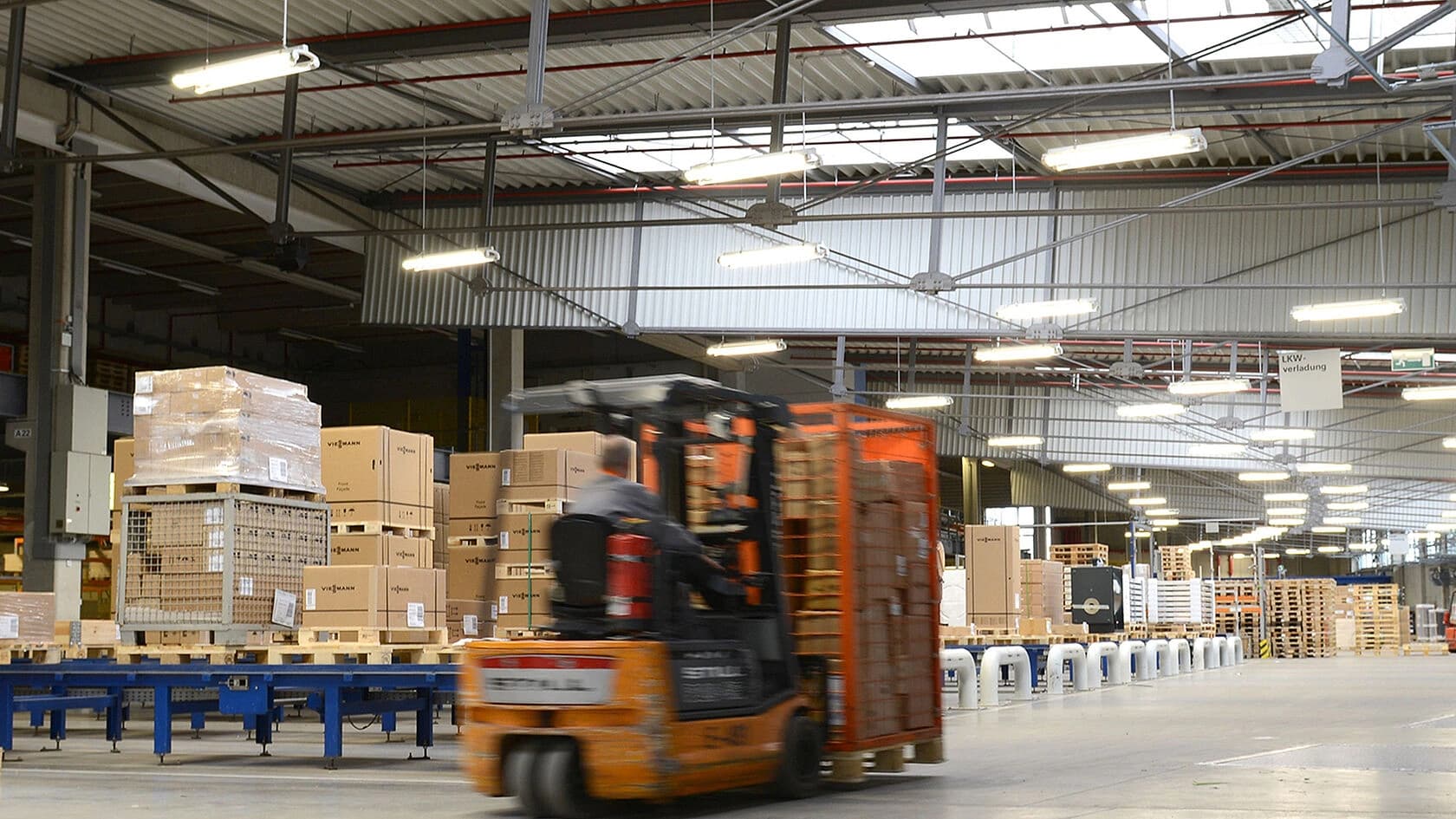 A forklift maneuvering through Viessmann's warehouse, transporting goods between shelves and storage areas.