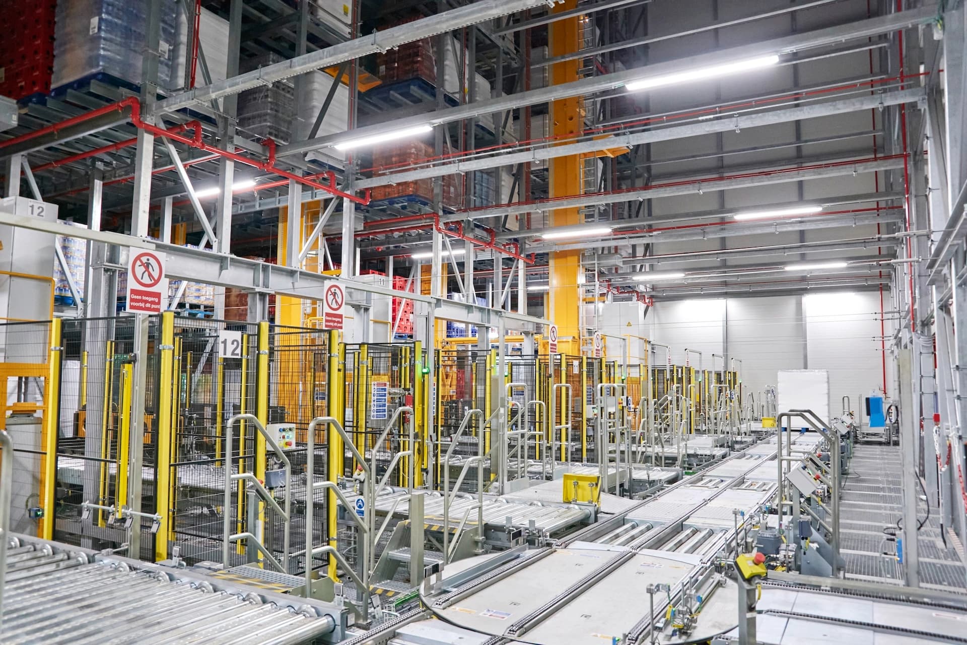 Coca-Cola Europacific Partners’ warehouse filled with numerous conveyor belts and industrial equipment for efficient material handling.