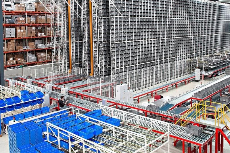 Photo showcasing the inside of a warehouse with multiple pallets.