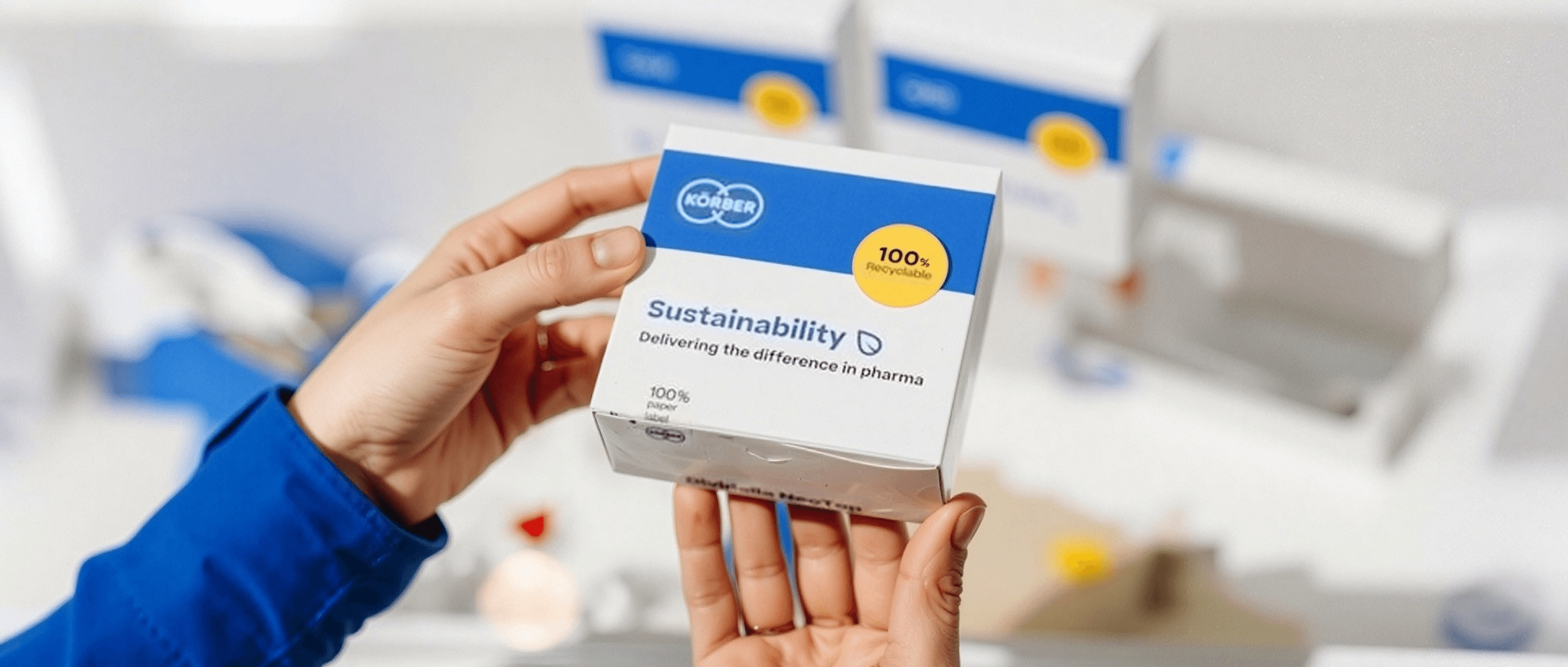 Close-up of hands holding Körber pharmaceutical packaging