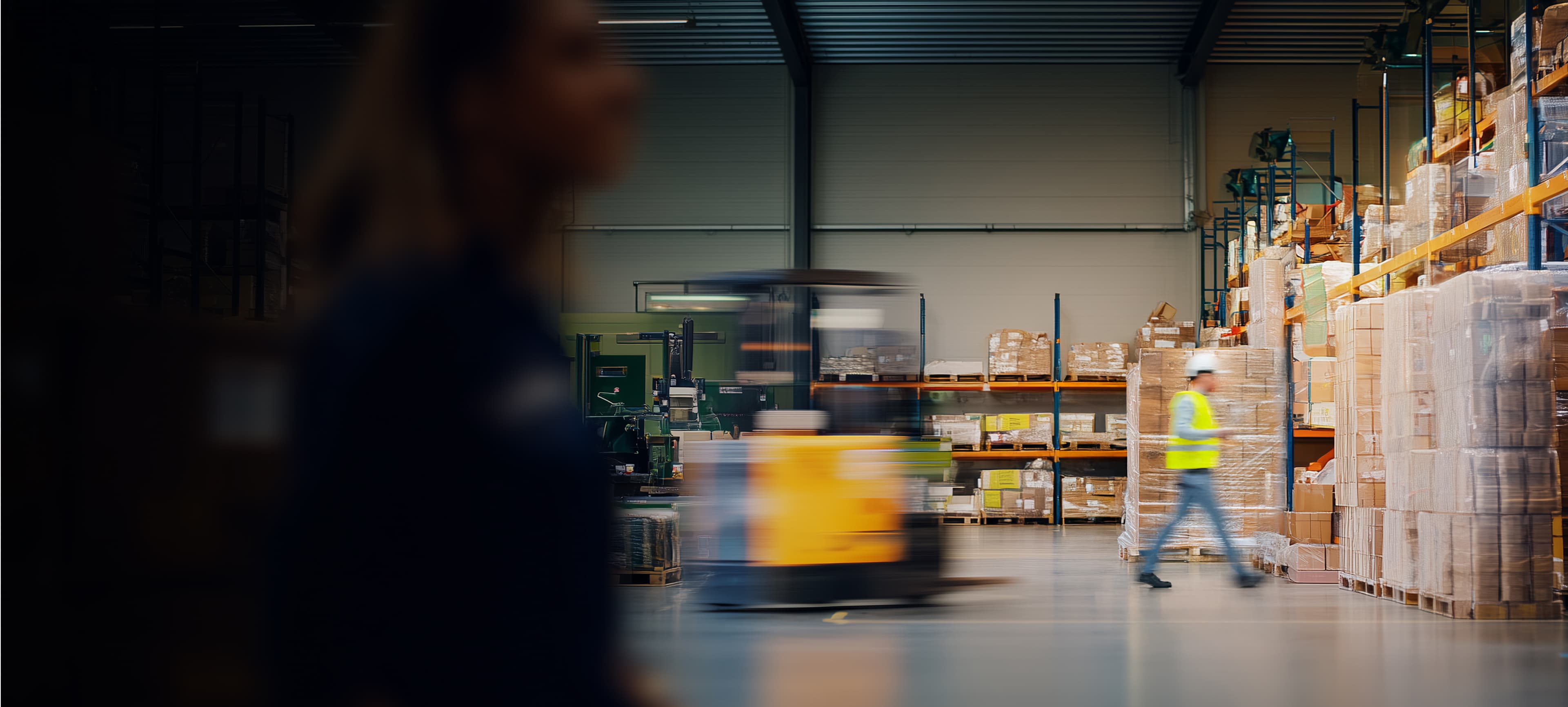 People in a warehouse with a forklift