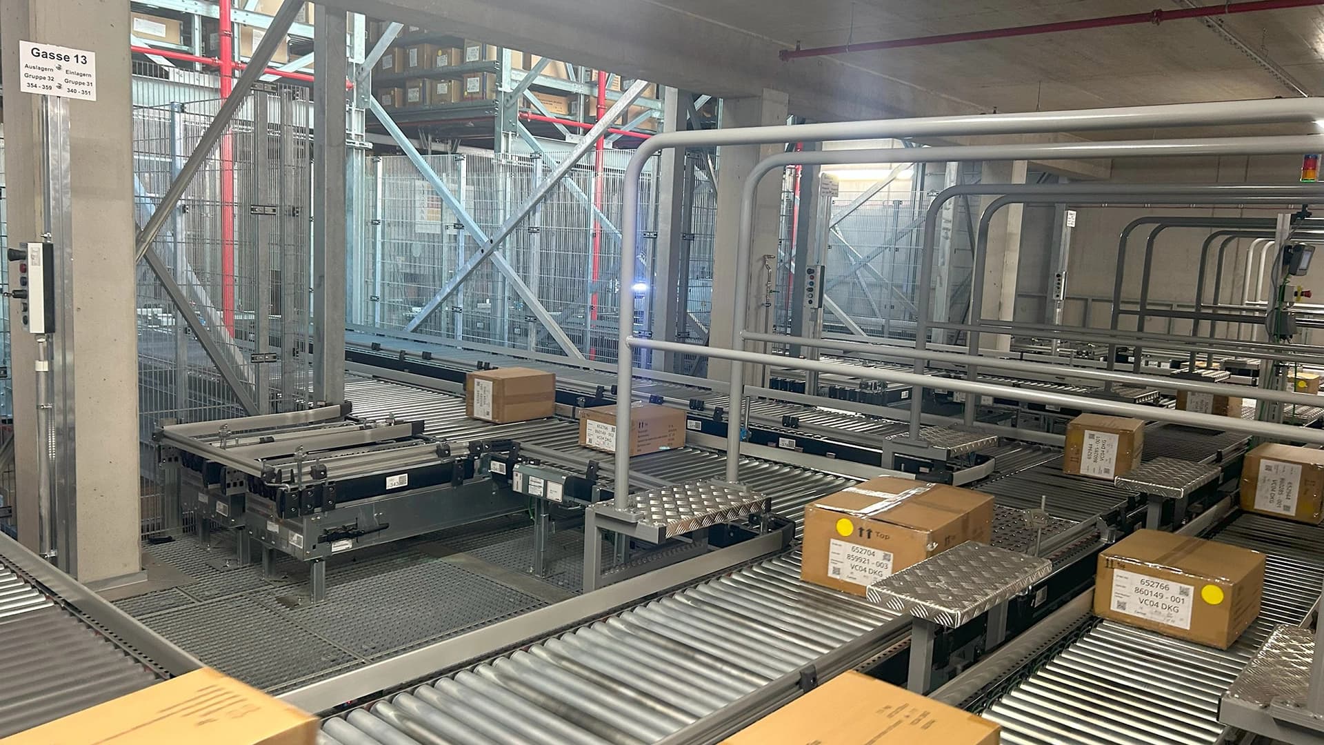 Packages moving along a conveyor in a warehouse supply chain line.