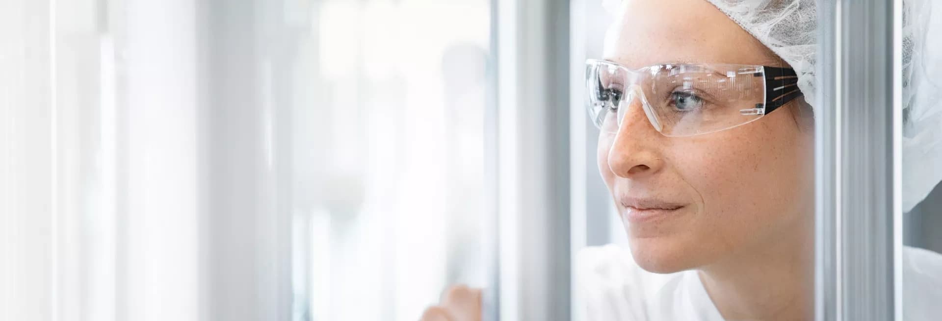 Close up of a woman with lab goggles.