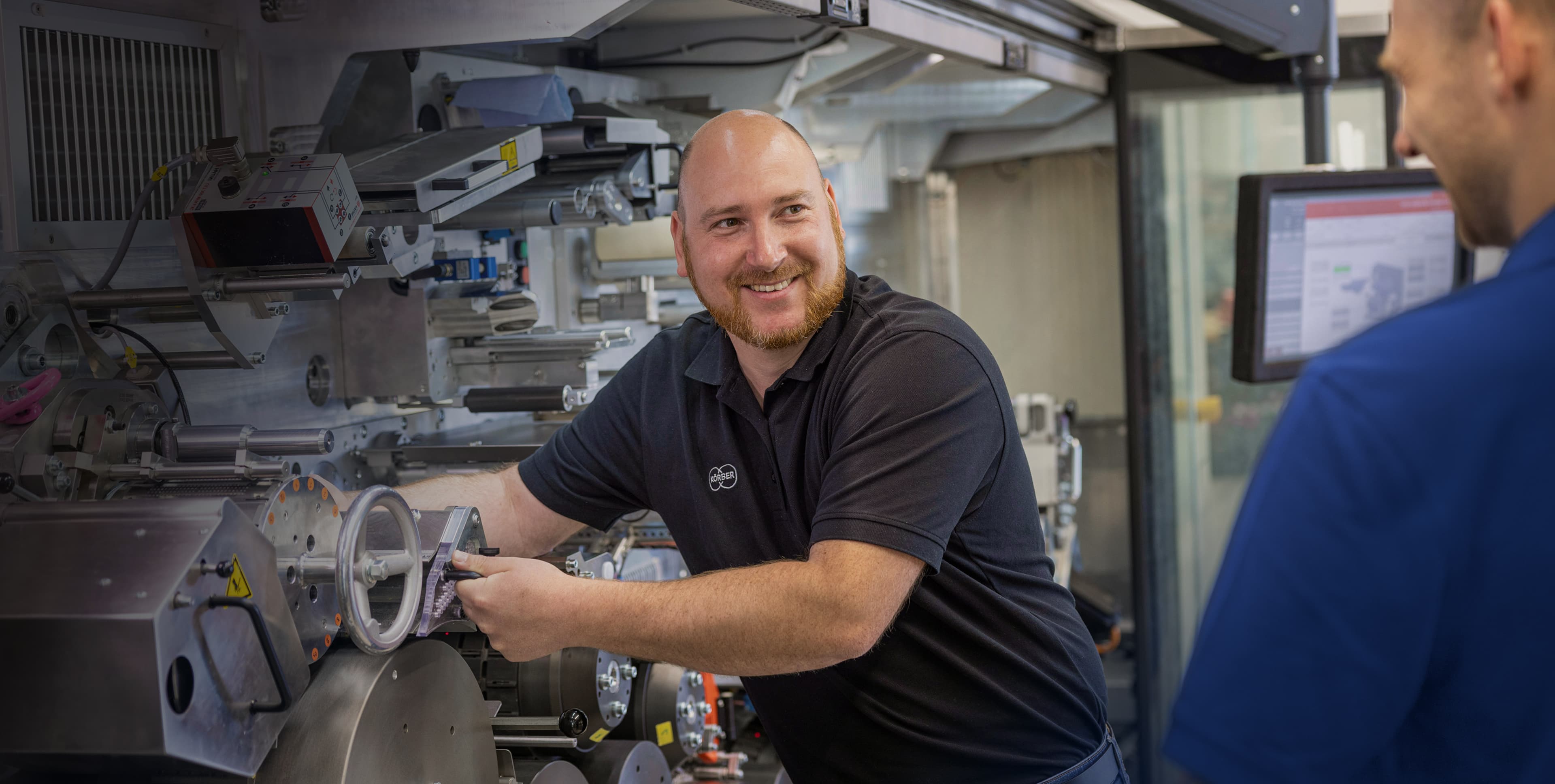 Körber technician maintaining manufacturing equipment