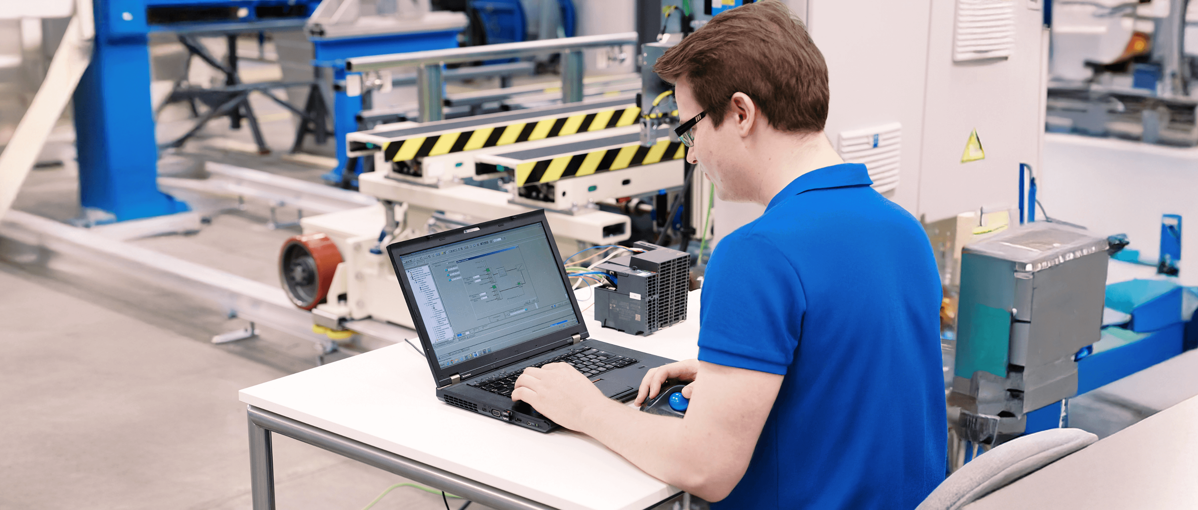 Man working on a laptop in a factory