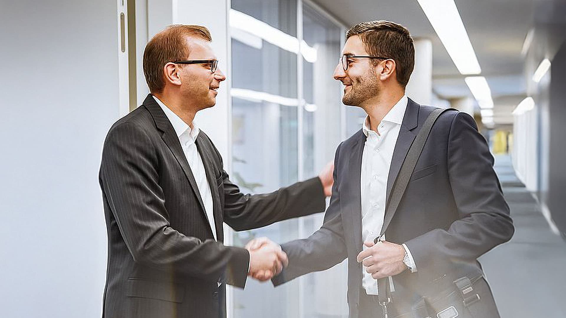 Two men shaking hands in business collaboration